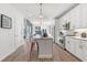 Open concept kitchen with white cabinets, granite countertops, and a large island at 392 Pratt Se Dr # 2023, Atlanta, GA 30315