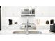 Modern kitchen sink and faucet with white quartz countertop at 392 Pratt Se Dr # 2023, Atlanta, GA 30315