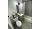 Updated bathroom with gray tile, patterned floor, and bathtub at 215 Piedmont Ne Ave # 1905, Atlanta, GA 30308