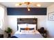 Bedroom with a rustic wood headboard, blue walls, and stylish decor at 215 Piedmont Ne Ave # 1905, Atlanta, GA 30308