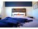 Cozy bedroom with rustic wood headboard and blue accents at 215 Piedmont Ne Ave # 1905, Atlanta, GA 30308