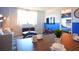 Modern dining area with wood table and blue accent chairs at 215 Piedmont Ne Ave # 1905, Atlanta, GA 30308
