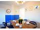 Dining area with wood table, blue chairs, and a modern light fixture at 215 Piedmont Ne Ave # 1905, Atlanta, GA 30308