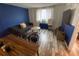 Living area with blue accent wall, dining table, and wood flooring at 215 Piedmont Ne Ave # 1905, Atlanta, GA 30308