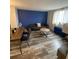 Living room features a blue accent wall and wood-look floors at 215 Piedmont Ne Ave # 1905, Atlanta, GA 30308