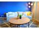Living room features a blue accent wall and a comfy sofa at 215 Piedmont Ne Ave # 1905, Atlanta, GA 30308