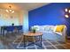 Living room with blue accent wall, comfy sofa, and wood-look floors at 215 Piedmont Ne Ave # 1905, Atlanta, GA 30308