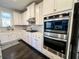 White kitchen cabinets and stainless steel appliances at 7860 Bristol Valley Dr, Cumming, GA 30028