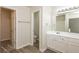Bathroom with white vanity, toilet and view into closet at 894 Churchill Ct, Stone Mountain, GA 30083