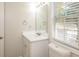 Simple bathroom with white vanity and a window at 894 Churchill Ct, Stone Mountain, GA 30083
