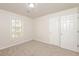 Bedroom with carpet, window, and double closets at 894 Churchill Ct, Stone Mountain, GA 30083