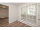 Bright dining room with hardwood floors and view into another room at 894 Churchill Ct, Stone Mountain, GA 30083
