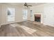 Living room with hardwood floors, fireplace, and ceiling fan at 894 Churchill Ct, Stone Mountain, GA 30083