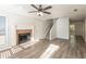 Living room with fireplace, hardwood floors, and ceiling fan at 894 Churchill Ct, Stone Mountain, GA 30083