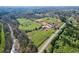 Aerial view showing stables, paddocks, and creek at 2431 Perkerson Mill Rd, Austell, GA 30106