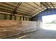 Simple, open barn with wooden stalls and open space at 2431 Perkerson Mill Rd, Austell, GA 30106