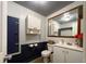 Clean and functional bathroom with white cabinets and a large mirror at 2431 Perkerson Mill Rd, Austell, GA 30106