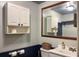 Clean bathroom with white cabinets, a large mirror, and a toilet at 2431 Perkerson Mill Rd, Austell, GA 30106