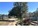 Driveway entrance with trees and shrubs at 2431 Perkerson Mill Rd, Austell, GA 30106