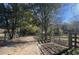 Gravel driveway leads to the property with wooden fencing at 2431 Perkerson Mill Rd, Austell, GA 30106