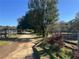 Long driveway leading to property with wooden fence at 2431 Perkerson Mill Rd, Austell, GA 30106