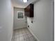 Bright laundry room with tile flooring and built-in cabinets at 4359 Parkview Dr, Lithia Springs, GA 30122