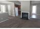 Living room with a fireplace, carpet, and views into the kitchen at 3791 River Lake Shr, Ellenwood, GA 30294