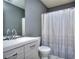 Bathroom with single vanity, shower, and toilet at 8432 Browns Mill Trce, Stonecrest, GA 30038