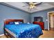 Spacious bedroom with a ceiling fan and blue bedding at 8432 Browns Mill Trce, Stonecrest, GA 30038