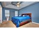 Bedroom with a ceiling fan and blue bedding at 8432 Browns Mill Trce, Stonecrest, GA 30038