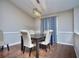 Bright dining room with hardwood floors and a modern light fixture at 8432 Browns Mill Trce, Stonecrest, GA 30038