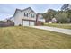 House exterior showcasing a two-car garage and landscaping at 8432 Browns Mill Trce, Stonecrest, GA 30038