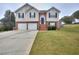 Two-story house with attached two-car garage and a brick facade at 8432 Browns Mill Trce, Stonecrest, GA 30038