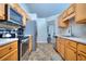 Kitchen boasts stainless steel appliances and light wood cabinets at 8432 Browns Mill Trce, Stonecrest, GA 30038