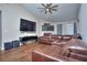 Spacious living area with hardwood floors and a large TV at 8432 Browns Mill Trce, Stonecrest, GA 30038