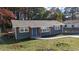 Newly renovated one-story home with gray siding and a landscaped lawn at 26 Reeves St, Norcross, GA 30071