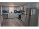 Modern kitchen with gray cabinets, granite countertops, and stainless steel appliances at 26 Reeves St, Norcross, GA 30071