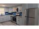 Modern kitchen with gray cabinets, granite countertops, and stainless steel appliances at 26 Reeves St, Norcross, GA 30071