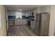 Modern kitchen with gray cabinets, granite countertops, and stainless steel appliances at 26 Reeves St, Norcross, GA 30071