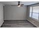 Spacious living room featuring gray walls, wood-look floors, and a ceiling fan at 26 Reeves St, Norcross, GA 30071