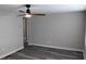 Bright living room with gray walls, wood-look floors, and ceiling fan at 26 Reeves St, Norcross, GA 30071