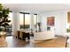 Modern living room boasts a curved sofa, fireplace, and expansive windows with city views at 3107 Peachtree Ne Rd # 1502, Atlanta, GA 30305