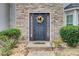 Elegant front door with stone surround and seasonal wreath at 3579 Oakshire Se Way, Atlanta, GA 30354