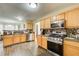 Kitchen with light wood cabinets, stainless steel appliances, and mosaic backsplash at 3579 Oakshire Se Way, Atlanta, GA 30354