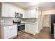 Modern kitchen with white cabinets, granite counters, and stainless steel appliances at 3661 Collins Dr, Douglasville, GA 30135