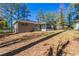 Spacious backyard with a screened porch and mature trees at 6677 Songwood Dr, Austell, GA 30168