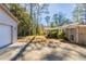 Large backyard with trees and access from garage and house at 6677 Songwood Dr, Austell, GA 30168