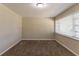 Spacious carpeted bedroom with neutral walls and window at 6677 Songwood Dr, Austell, GA 30168