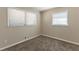 Well-lit bedroom with neutral carpeting and window at 6677 Songwood Dr, Austell, GA 30168