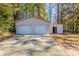 Two-car garage with extra storage space and driveway at 6677 Songwood Dr, Austell, GA 30168